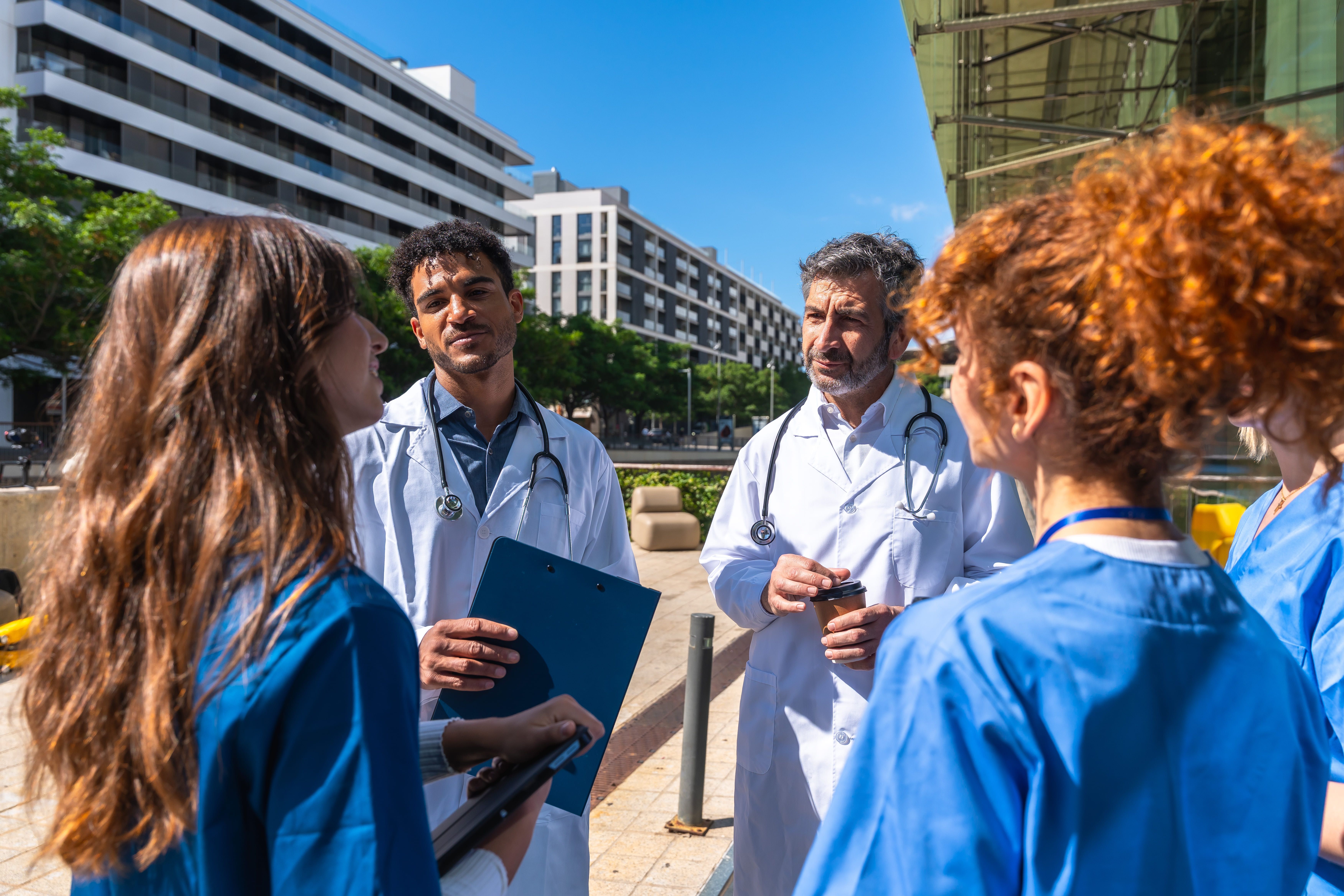 Multidisciplinary medical team collaborating near a health facility